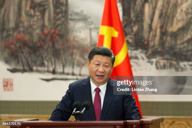 Chinese President Xi Jinping speaks at the podium during the unveiling of the Communist Party's new Politburo Standing Committee at the Great Hall of...