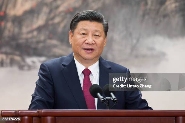 Chinese President Xi Jinping speaks at the podium during the unveiling of the Communist Party's new Politburo Standing Committee at the Great Hall of...