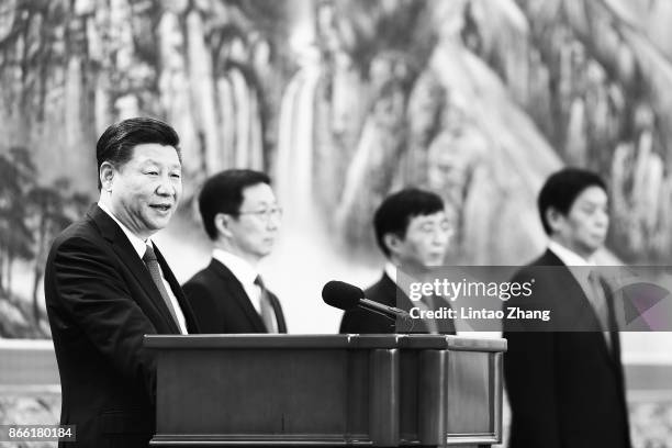 Chinese President Xi Jinping speaks at the podium during the unveiling of the Communist Party's new Politburo Standing Committee at the Great Hall of...