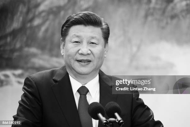 Chinese President Xi Jinping speaks at the podium during the unveiling of the Communist Party's new Politburo Standing Committee at the Great Hall of...