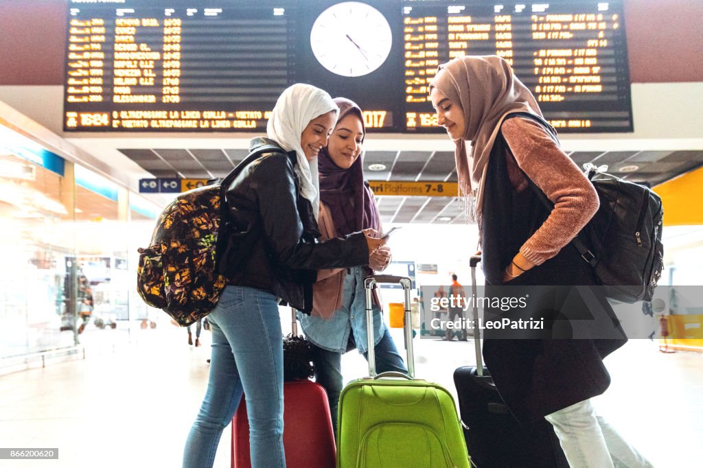 Young muslim women at train station leaving for a journey