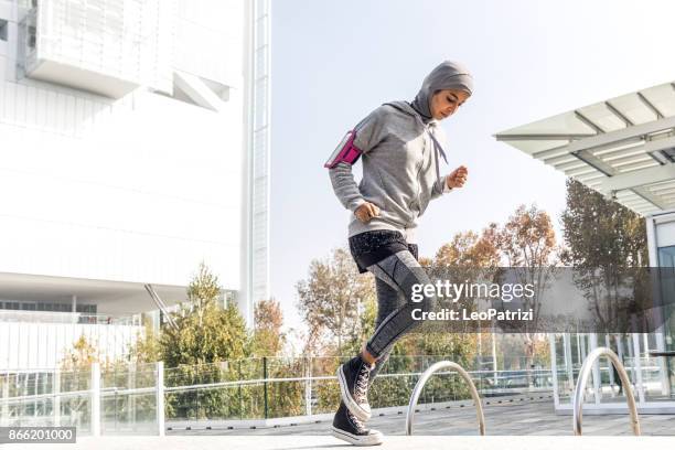 young muslim woman ready to running in the city - women with hijab stock pictures, royalty-free photos & images