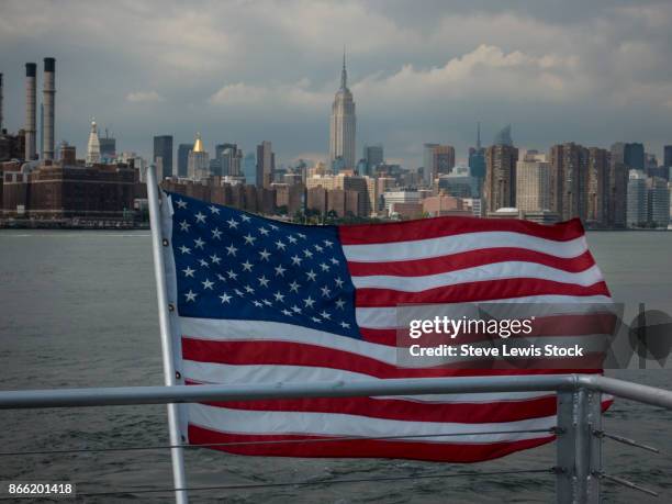 american flag with the manhattan skyline. - lewis ferry stock pictures, royalty-free photos & images