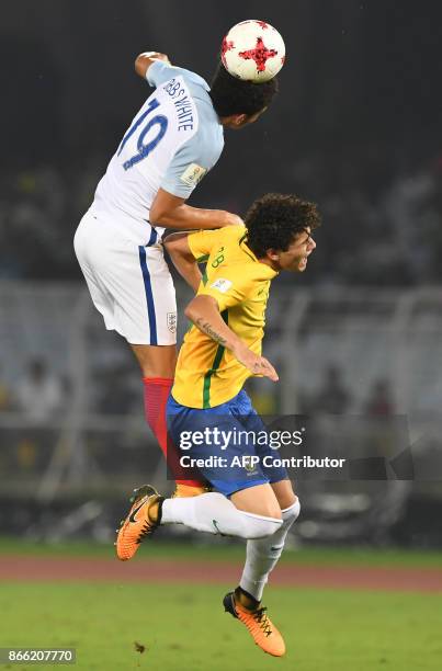 Lucas Halter of Brazil fights for the ball with Morgan Gibbs White of England during the semifinal football match in the FIFA U-17 World Cup at the...