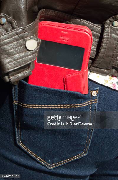 woman carrying smartphone in back pocket - phone in back pocket stock pictures, royalty-free photos & images