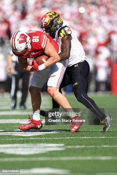 Troy Fumagalli of the Wisconsin Badgers is brought down by Darnell Savage Jr. #4 of the Maryland Terrapins during a game at Camp Randall Stadium on...