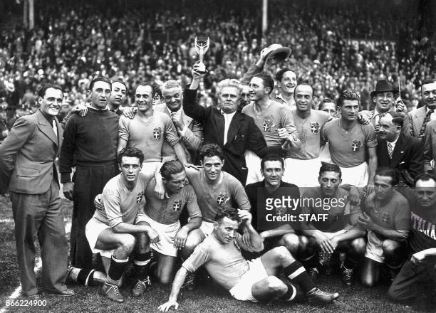 Italy's national soccer team poses with the World Cup trophy after beating Hungary 4-2 in the World Cup final, 19 June 1938 in Colombes, in the...