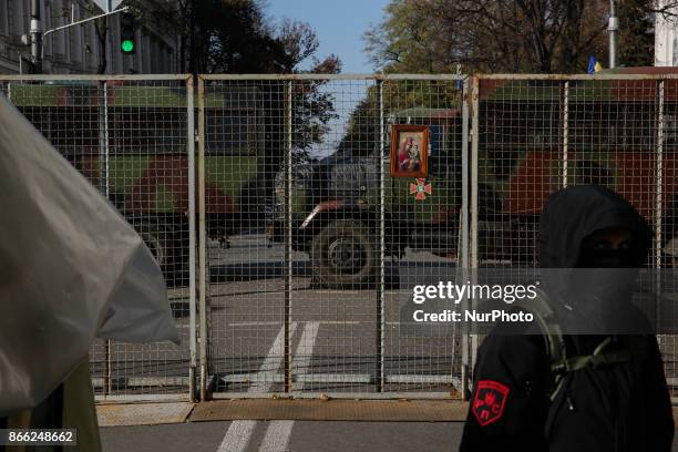 Protester walks past the fence isolating a camp from the city in Kyiv, Ukraine, Oct.25, 2017. Dozens Ukrainians set up a tent camp in front of...