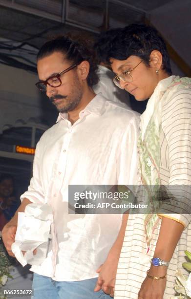 Indian Bollywood actor Aamir Khan and his wife, director Kiran Rao attend a prayer meeting for film director Ram Mukherjee in Mumbai on October 25,...