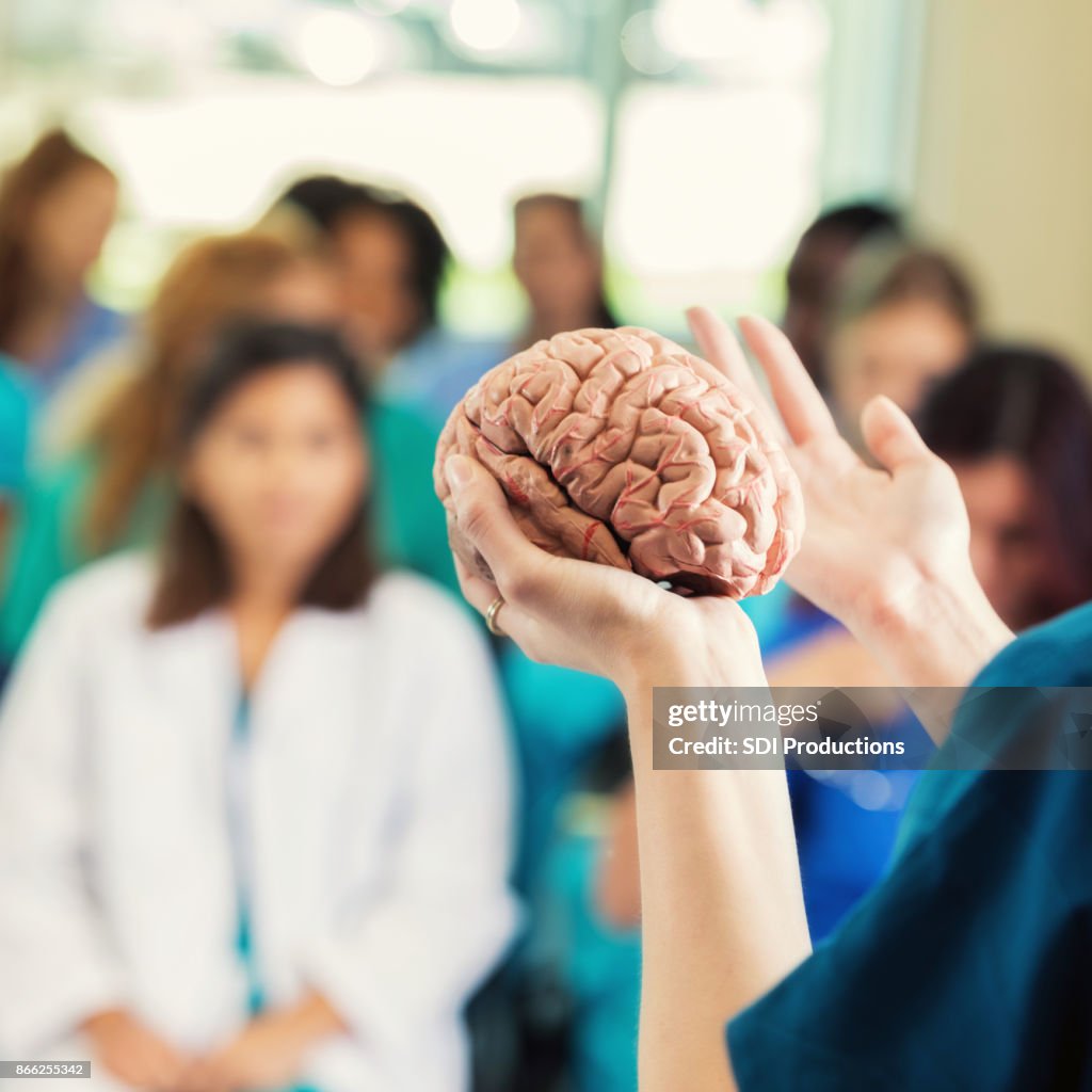 Unrecognizable neurologist teaches continuing education class