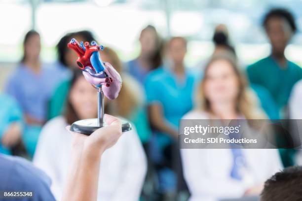 unrecognizable cardiologist addresses colleagues during healthcare conference - organe de reproduction masculin imagens e fotografias de stock