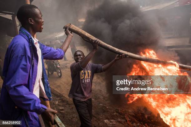 Opposition supporters burn tires in protest for presidential candidate Raila Odinga, in the Kibera slum on October 25, 2017 in Nairobi, Kenya....