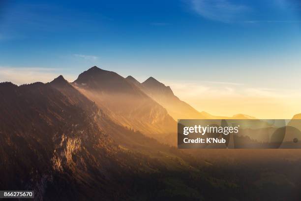 swiss alps, high mountain, in sunset time view from harder kulm viewpoint - mountain sunset stock pictures, royalty-free photos & images