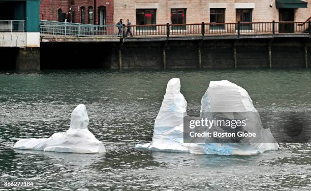 Iceberg," a sculpture by artist Gianna Stewart, floats in the Fort Point Channel in Boston on Oct. 24, 2017. Intended as a reminder about global...