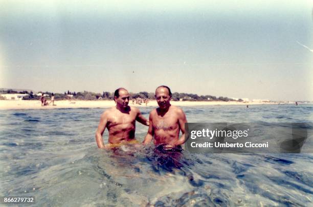 Silvio Berlusconi at the beach with Fedele Confalonieri in Hammamet in Tunisia in August 1984. There was even Bettino Craxi with them, but he is not...