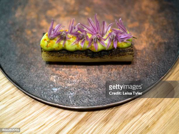 Charred leek with wild chive flowers cooked by Pai Holmberg from Bifångst, a two seat restaurant in Gothenberg. Ms Holmberg carries a no-waste moto...