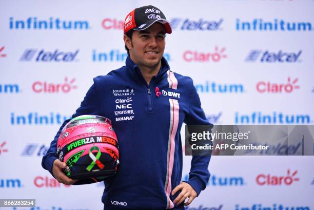 Sahara India Force Mexican driver Sergio "Checo" Perez poses for pictures after a press conference in Mexico City, on October 25, 2017 ahead of the...