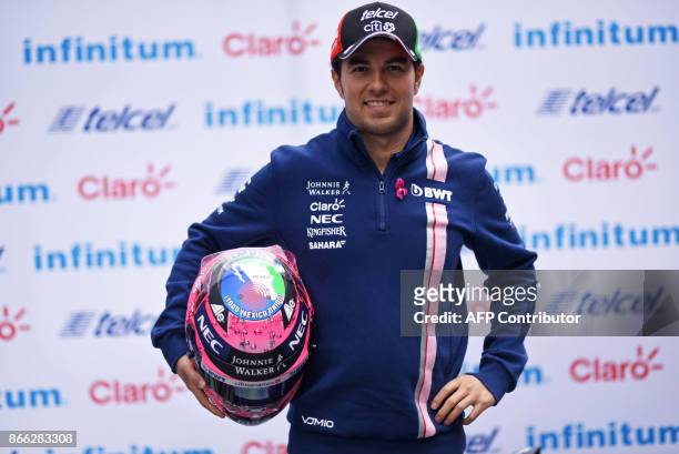Sahara India Force Mexican driver Sergio "Checo" Perez poses for pictures after a press conference in Mexico City, on October 25, 2017 ahead of the...