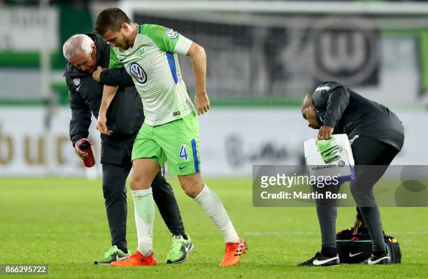 Ignacio Camacho of Wolfsburg walks injured off the pitch during the DFB Cup match between VfL Wolfsburg and Hannover 96 at Volkswagen Arena on...