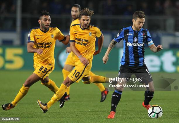 Alejandro Dario of Atalanta BC is challenged by Alessio Cerci and Mohamed Fares of Hellas Verona FC during the Serie A match between Atalanta BC and...