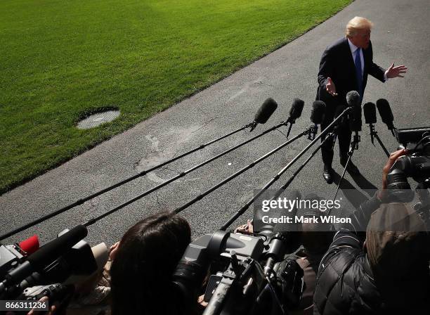 President Donald Trump speaks to reporters before boarding Marine One to depart from the White House on October 25, 2017 in Washington DC. President...