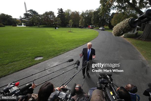 President Donald Trump speaks to reporters before boarding Marine One to depart from the White House on October 25, 2017 in Washington DC. President...