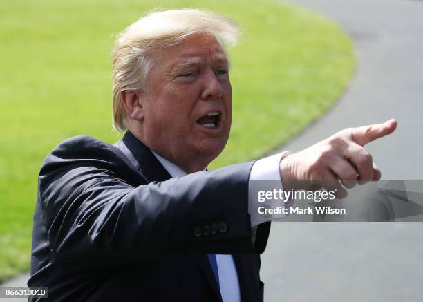 President Donald Trump speaks to reporters before boarding Marine One to depart from the White House on October 25, 2017 in Washington DC. President...