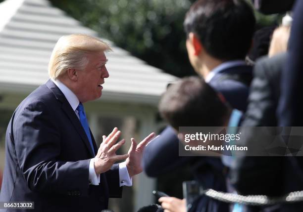 President Donald Trump speaks to reporters before boarding Marine One to depart from the White House on October 25, 2017 in Washington DC. President...