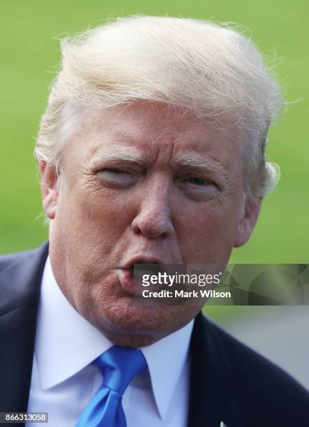 President Donald Trump speaks to reporters before boarding Marine One to depart from the White House on October 25, 2017 in Washington DC. President...