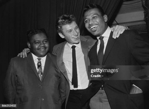 File picture taken on October 20, 1962 shows US pianist and singer-songwriter Fats Domino being congratulated by French singer Johnny Hallyday and US...