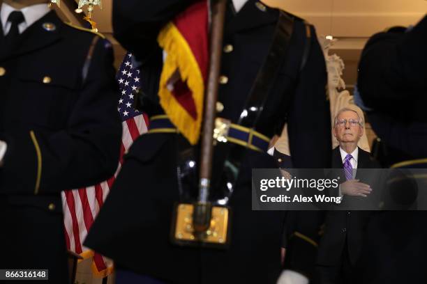 Senate Majority Leader Sen. Mitch McConnell listens to the national anthem during a Congressional Gold Medal presentation ceremony October 25, 2017...