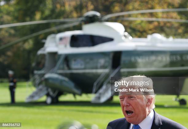 President Donald Trump speaks to reporters before boarding Marine One to depart from the White House on October 25, 2017 in Washington DC. President...