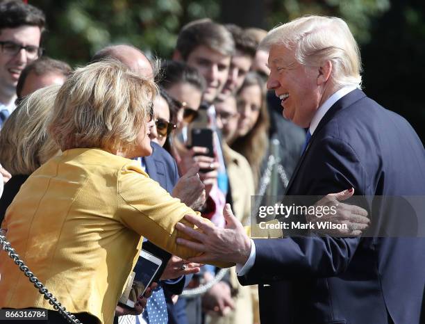 President Donald Trump greets well wishers before boarding Marine One to depart from the White House on October 25, 2017 in Washington DC. President...