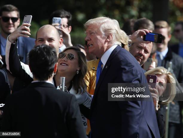 President Donald Trump greets well wishers before boarding Marine One to depart from the White House on October 25, 2017 in Washington DC. President...