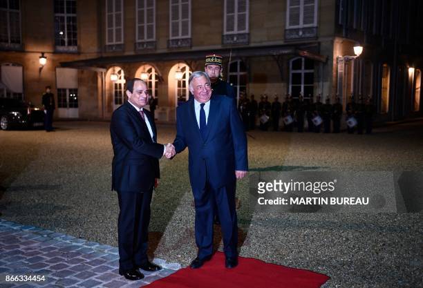 French Senate President Gerard Larcher shakes hands with Egyptian President Abdel Fattah al-Sisi upon arrival for a meeting at the Senate in Paris on...