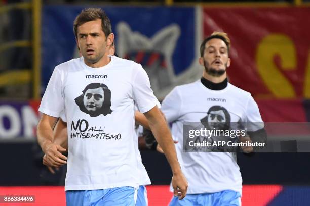 Lazio's midfielder from Bosnia-Herzegovina Senad Lulic wears a t-shirt showing an image of holocaust victim Anne Frank, during the warm up prior the...