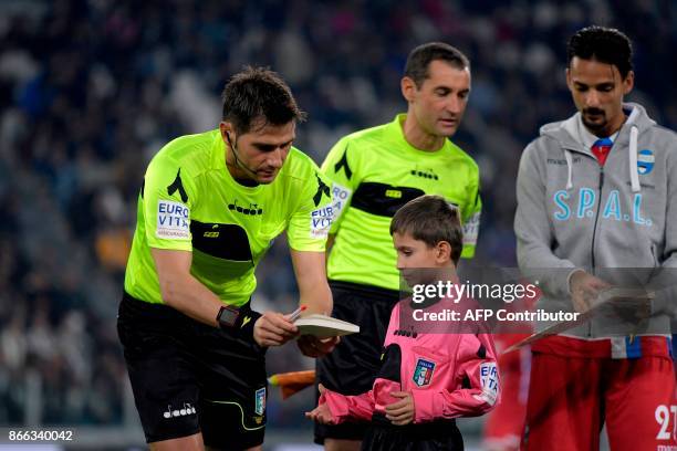 Referee Fabrizio Pasqua gives a copy of the diary of holocaust victim Anne Frank to a boy before the Italian Serie A football match Juventus vs Spal,...