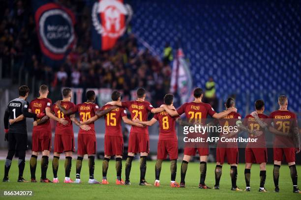 Roma's players listen to a speaker reading a passage from the diary of holocaust victim Anne Frank before the Italian Serie A football match AS Roma...