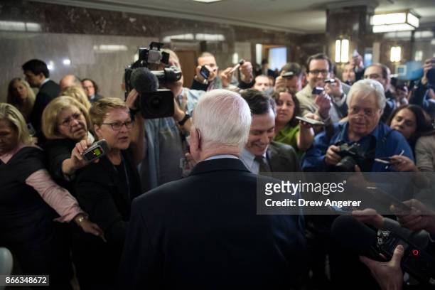 Sen. John McCain talks to reporters after a brief press conference before an Armed Services conference committee meeting on the National Defense...