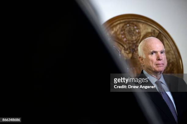 Sen. John McCain looks on during a brief press conference before an Armed Services conference committee meeting on the National Defense Authorization...