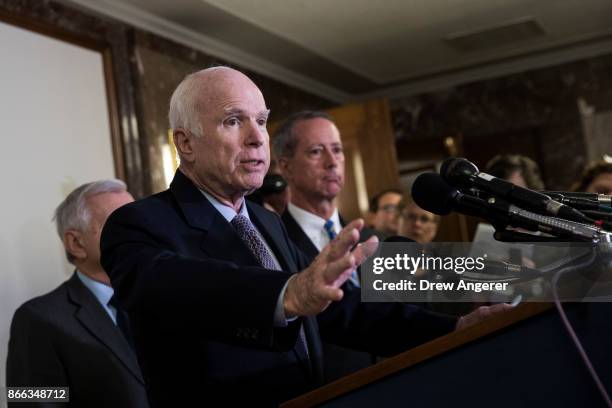 Rep. Mac Thornberry looks on Sen. John McCain speaks during a brief press conference before an Armed Services conference committee meeting on the...