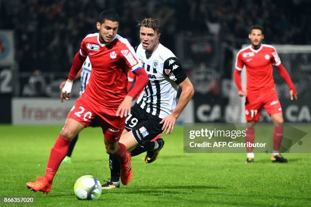 Nancy's French defender Michael Chretien outruns Angers' French forward Baptiste Guillaume during the French League Cup round of 16 football match...