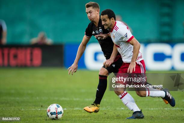 Dilly Duka of the New York Red Bulls and Russell Canouse of DC United battle for the ball in the first half at RFK Stadium on October 22, 2017 in...