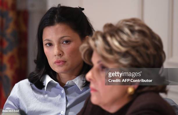 New alleged victim of film producer Harvey Weinstein, actor and model Natassia Malthe looks at ther Attorney Gloria Allred speaking during a press...