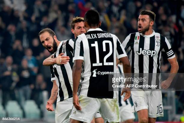 Juventus' Argentinian forward Gonzalo Higuain celebrates with teammates after scoring during the Italian Serie A football match Juventus vs Spal at...