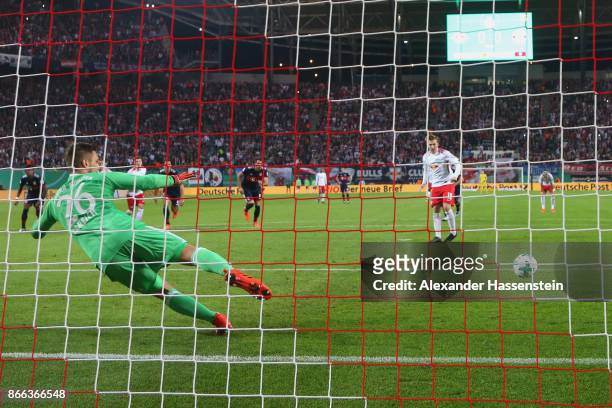 Emil Forsberg of Leipzig scores the opening goal with a penalty against Sven Ulreich, keeper of Muenchen during the DFB Cup round 2 match between RB...