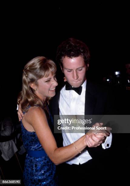 John McEnroe of the USA dancing with fellow tennis player Chris Evert-Lloyd at 'The Night of the Champions' event during the French Open Tennis...