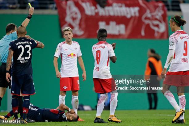 Referee Felix Zwayer gives the first yellow card to Naby Keita of RB Leipzig during the German DFB Pokal match between RB Leipzig v Bayern Munchen at...