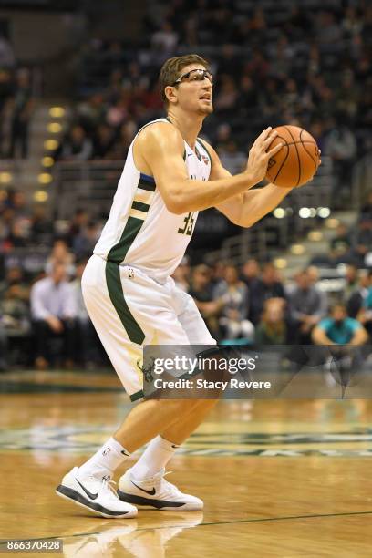 Mirza Teletovic of the Milwaukee Bucks takes a three point shot during a game against the Charlotte Hornets at the BMO Harris Bradley Center on...