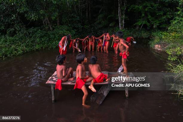 Waiapi men dance and play flute during the Anaconda's party -during which they make flutes to play and dance, and at the end leave all flutes on the...